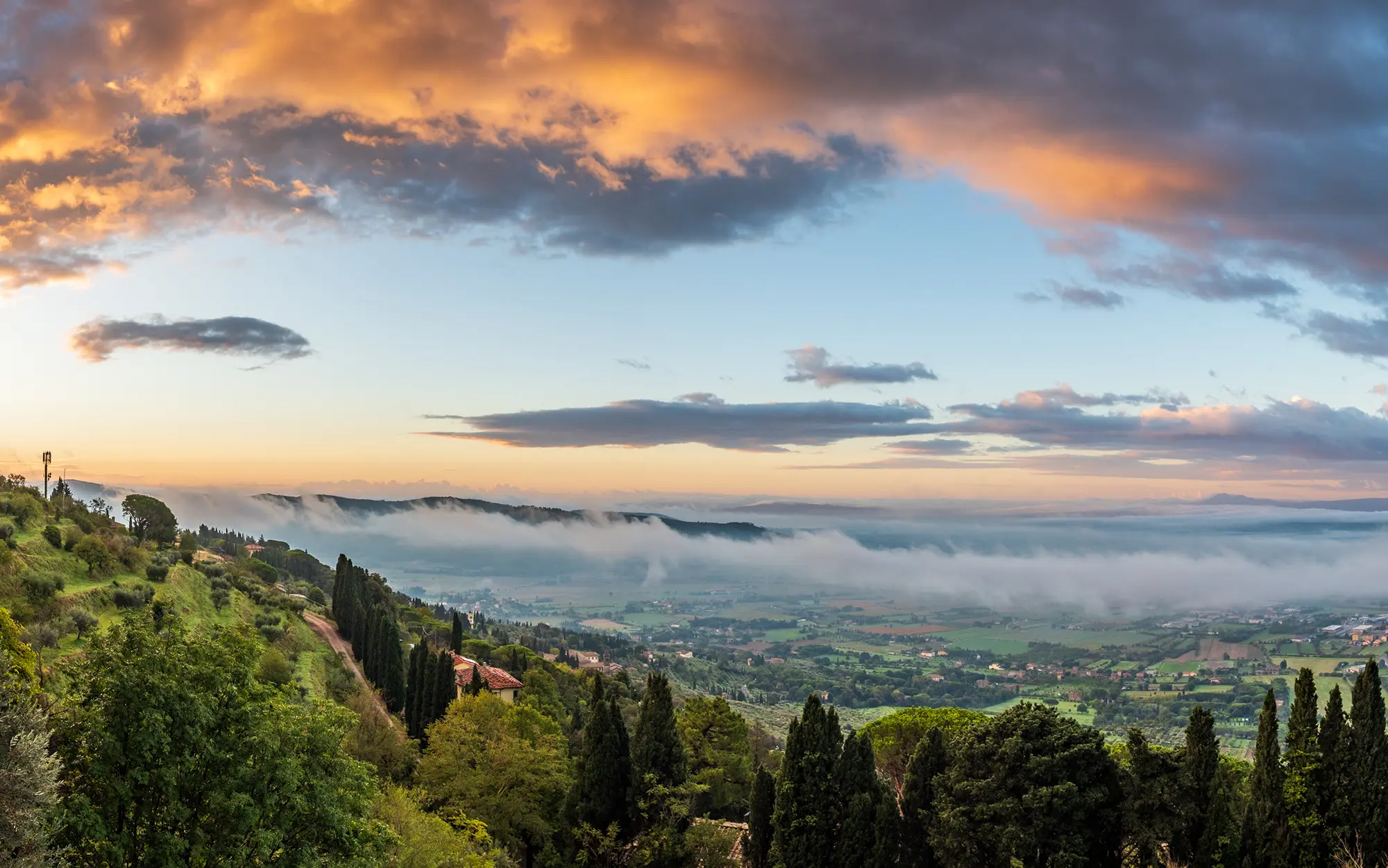 Sunrise over the Chiana Valley, as seen from Cortona on September 27, 2022.