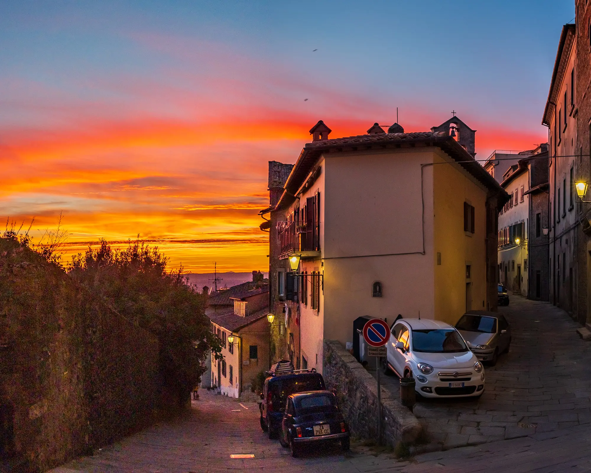 Sunset illuminates the Porta Berarda intersection in Cortona on November 6, 2022