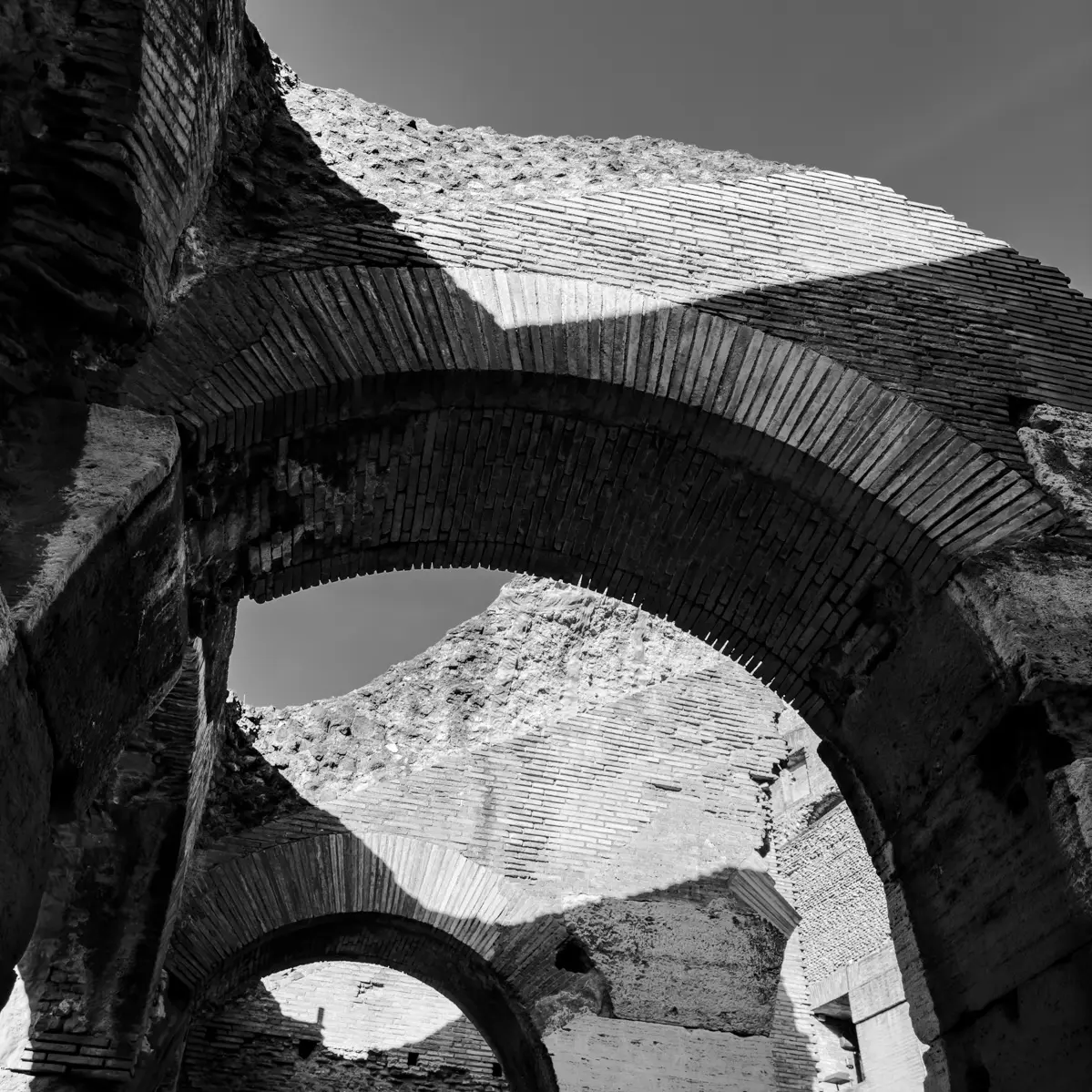 An digital photograph of an archway in the Colosseum in Rome, Italia. 