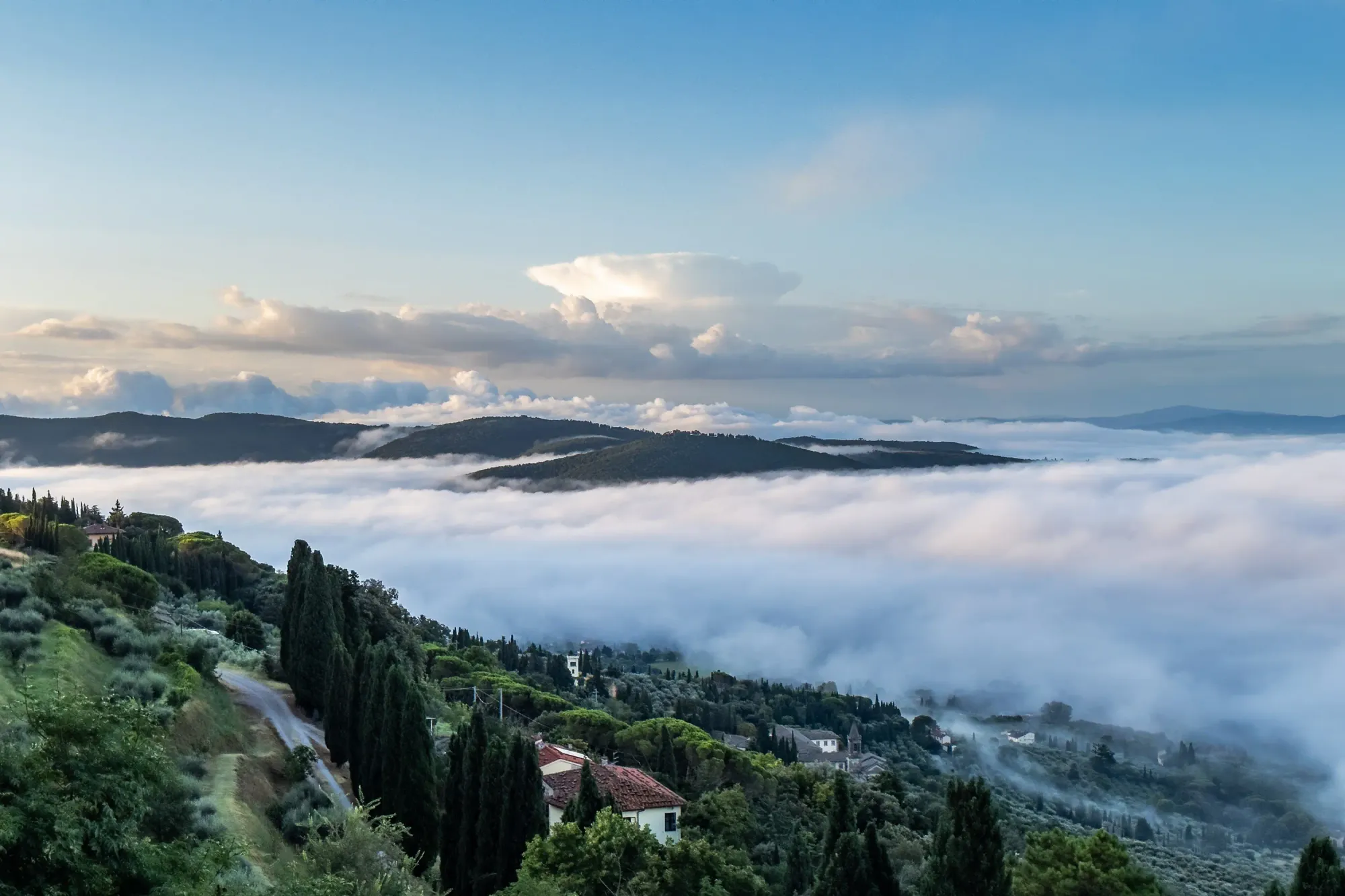 A rare cloud-filled valley effect below Cortona, Italia on August 5, 2023.