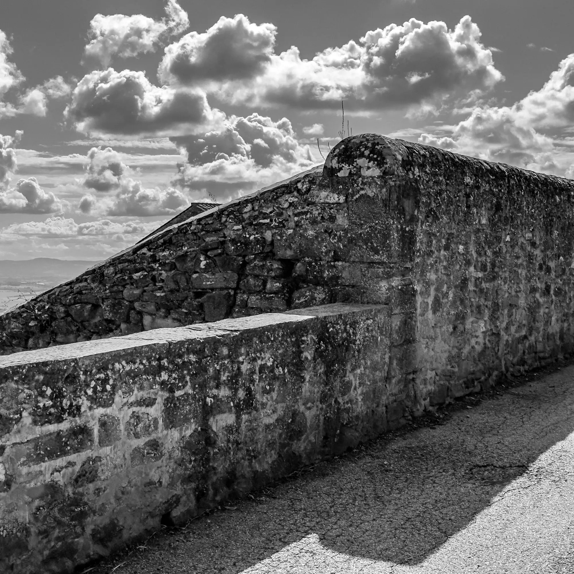 Intersecting stone walls on Via delle Santucce in Cortona, Italia.